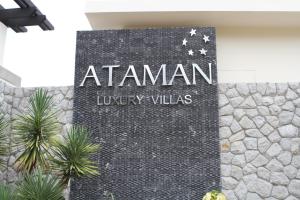 
a sign on the side of a building at Ataman Luxury Villas SHA Plus in Ko Kho Khao
