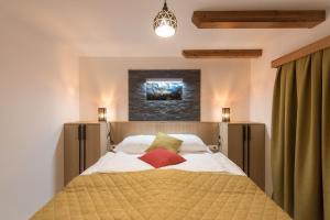 a bedroom with a bed with white sheets and pillows at Guesthouse Lajnar in Zgornja Sorica
