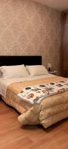 a large bed in a bedroom with a sqor at Castello Apartment Deluxe in Sciacca