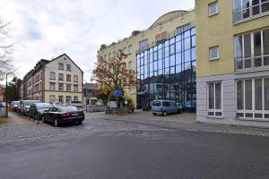 a city street with cars parked in front of buildings at Apartment Nürnberg Like Home in Nürnberg