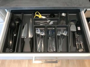 a tray filled with utensils in a drawer at Apartment Lilletveitvegen in Bergen