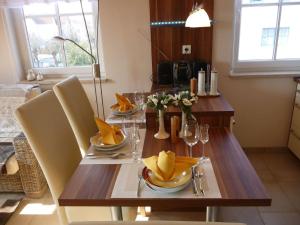 a wooden table with chairs and a dining room at Ferienwohnung Seeanemone I in Graal-Müritz