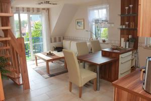 a kitchen with a table and a dining room at Ferienwohnung Seeanemone I in Graal-Müritz