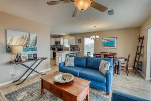 a living room with a blue couch and a table at Navarre Beach Sunset Condo in Navarre