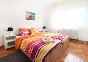 a bedroom with a large bed with towels on it at Zagreb Apartmani Santana in Zagreb