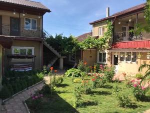 a garden in front of a house with flowers at Casa Lenuta in Mila Douăzeci şi Trei