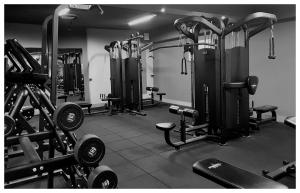 a gym with several rows of equipment in a room at Zajazd Bog-Mar in Rymanów