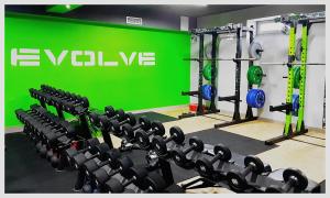 un gimnasio con una pared verde y filas de equipos de ejercicio en Zajazd Bog-Mar en Rymanów