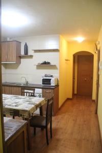 a kitchen with a table and a dining room at Hostal Maury in El Barraco