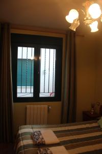 Postel nebo postele na pokoji v ubytování Hostal Maury