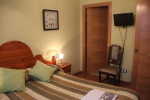 Postel nebo postele na pokoji v ubytování Hostal Maury