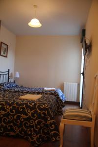 Postel nebo postele na pokoji v ubytování Hostal Maury