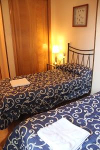 Postel nebo postele na pokoji v ubytování Hostal Maury