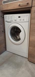 a white washer and dryer in a kitchen at Lukas Guest Rooms in Krakow