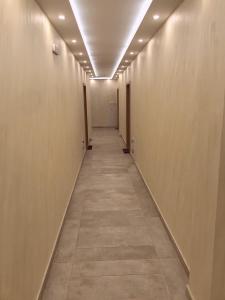 a corridor of an office building with a long hallway at Apartman Santorini in Novi Sad