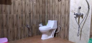 a bathroom with a toilet and a shower at N R Resort Kaziranga in Kāziranga +40 photos