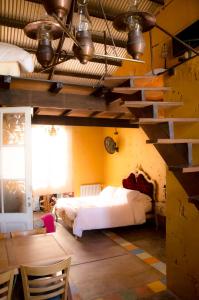 a bedroom with a large bed and a staircase at El Granero in Sierra de los Padres