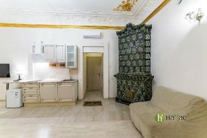 a kitchen with a table and a couch in a room at Hotel Bolshoy 19 in Saint Petersburg