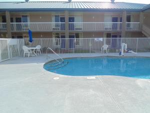 a swimming pool in front of a apartment building at Days Inn by Wyndham Adel I-75 in Adel