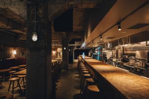 a bar with chairs and tables in a restaurant at Hotel K5 in Tokyo