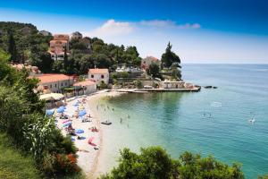 a group of people on a beach in the water at Apartments Villa Marijeta with Free Parking in Zaton