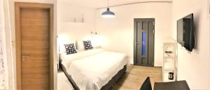 Postel nebo postele na pokoji v ubytování Apartments & Rooms Formenti