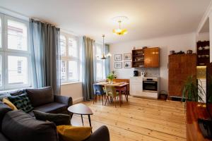 a living room with a couch and a table at Zeglarska Apartament in Toruń
