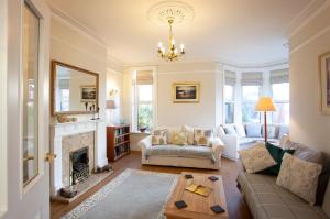 a living room with a couch and a fireplace at The Castleton in Swanage