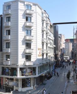 a white building on the side of a street at Hotel Falcon in Istanbul