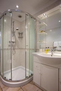 a bathroom with a shower and a sink at The Castleton in Swanage