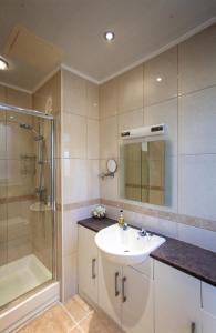 a bathroom with a sink and a shower at The Castleton in Swanage