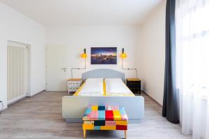 A bed or beds in a room at Lara's Guesthouse