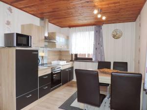 a kitchen with a table and chairs in a kitchen at Haus Walpurga in Schierke