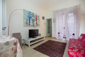 a living room with a bed and a tv at Foscolo in Viareggio