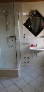 uma casa de banho com um chuveiro e um lavatório. em Wohnung Auerand em Nienhagen