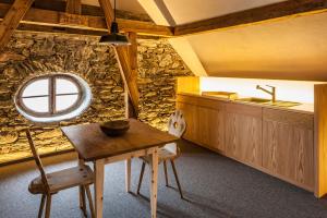 a kitchen with a table and a sink in a room at Josephus in Senales