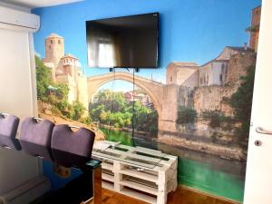 a room with a wall mural of a bridge at Apartment Mirela in Sarajevo