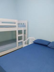 um quarto com um beliche e uma cama azul em Casa Gomes Itagua em Ubatuba