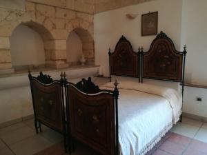 A bed or beds in a room at Masseria Caracci