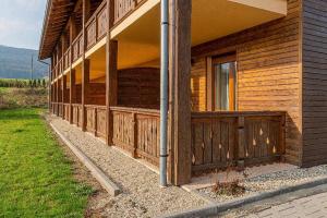 a wooden building with a door and a window at Apartmány Pod Sjezdovkou in Červená Voda