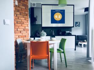 a kitchen with a table and chairs with a price sign at Ariel in Świnoujście