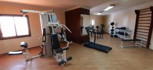 a gym with several treadmills and machines in a room at Sharm Holiday Resort in Sharm El Sheikh