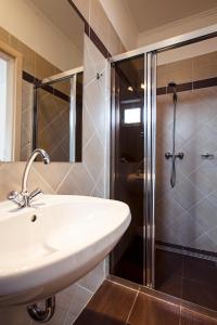 a bathroom with a sink and a shower at Kocsis Apartman és Camping in Mosonmagyaróvár