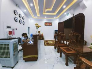 a woman sitting at a desk in a room at The Sun Hotel in Tây Ninh