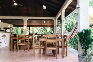 a restaurant with wooden tables and chairs on a patio at Star Mountain Jungle Lodge - Mal Pais, Santa Teresa in Mal País