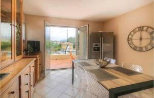 a kitchen with a large clock on the wall at Awesome Home In Algajola With Wifi in Algajola