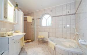 a white bathroom with a tub and a sink at Helle Ferienwohnung In Elmen in Elmen +8 photos