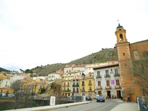 a city street with buildings and a clock tower at CASA KALIMERA in Cuenca