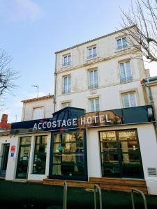 aacassette hotel on the side of a building at Accostage Hôtel Plage de la Concurrence in La Rochelle