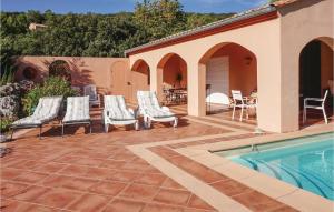 a patio with chairs and a swimming pool at Beautiful Home In Pierrerue in Pierrerue +15 photos